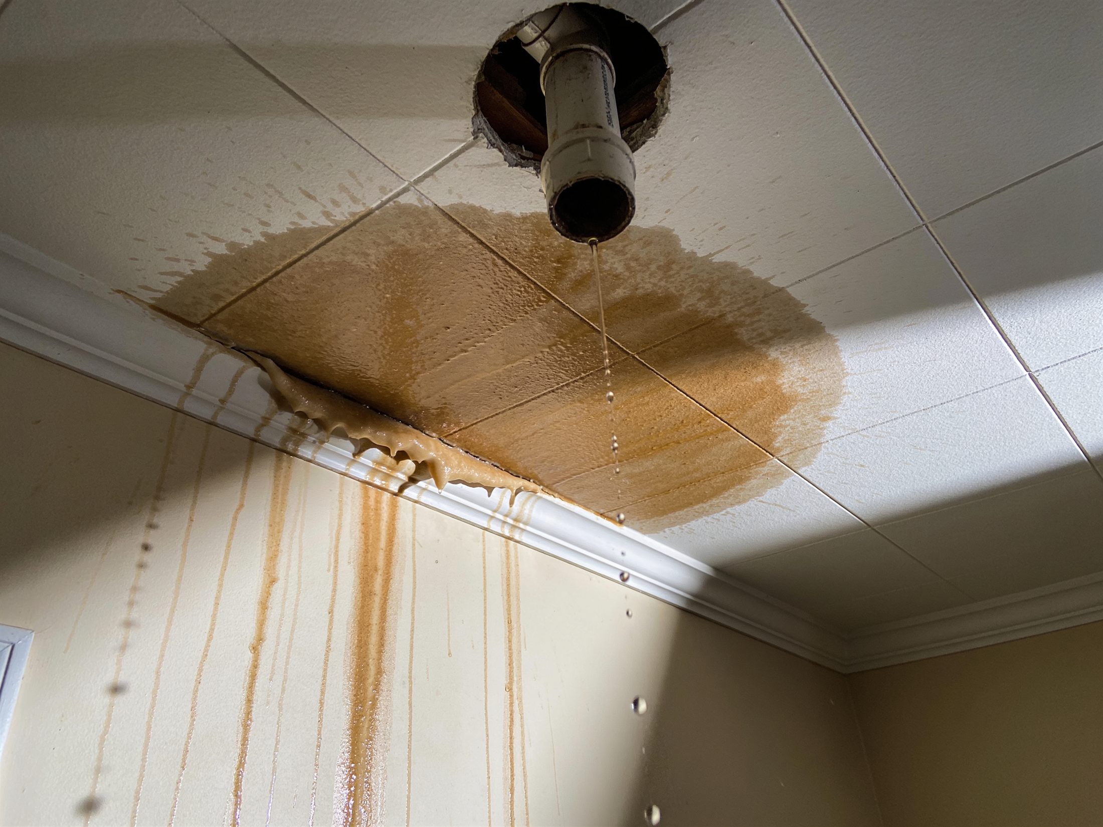 Water-stained ceiling dripping from a burst pipe above