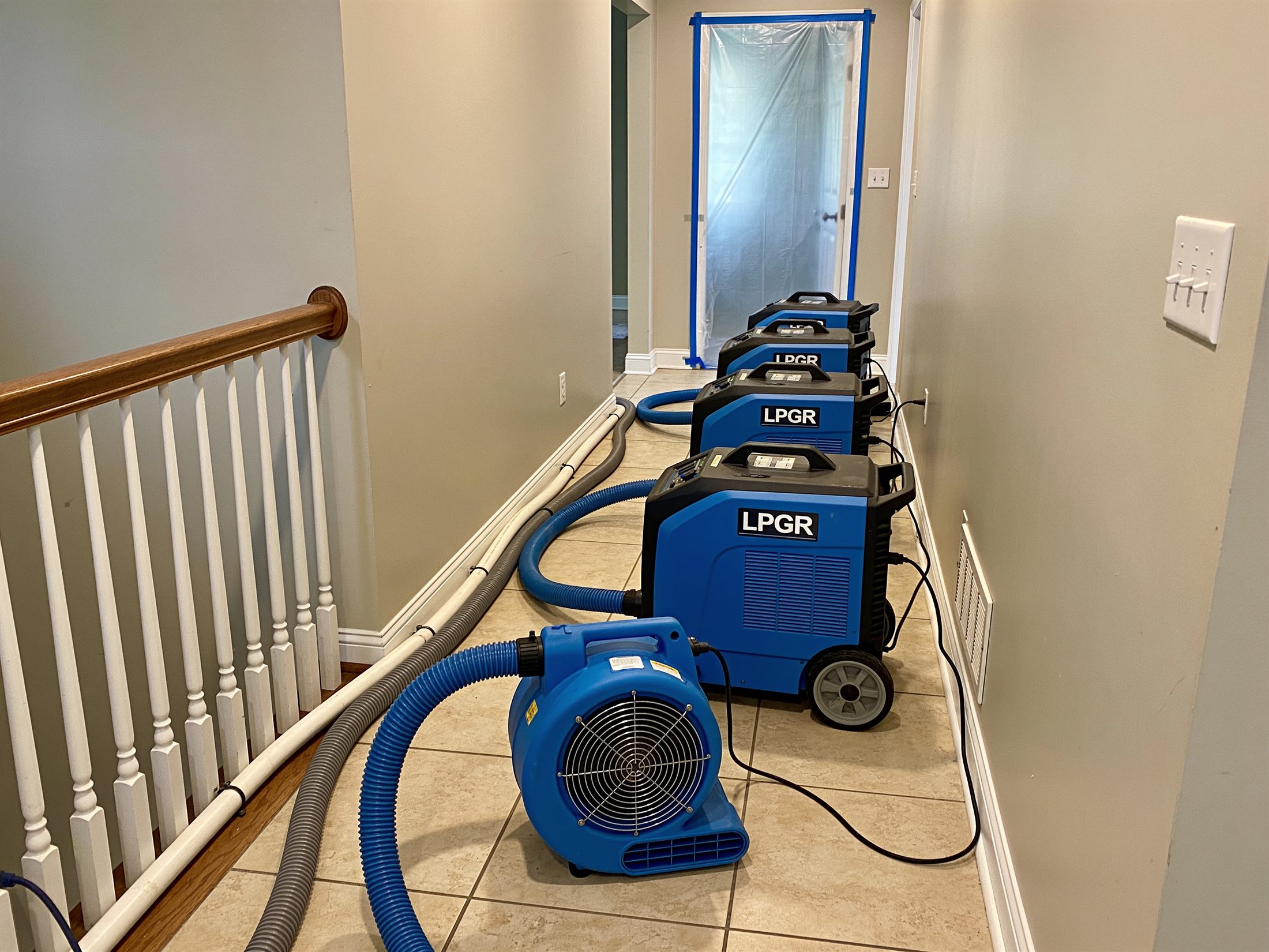Industrial dehumidifiers and air movers running in a home