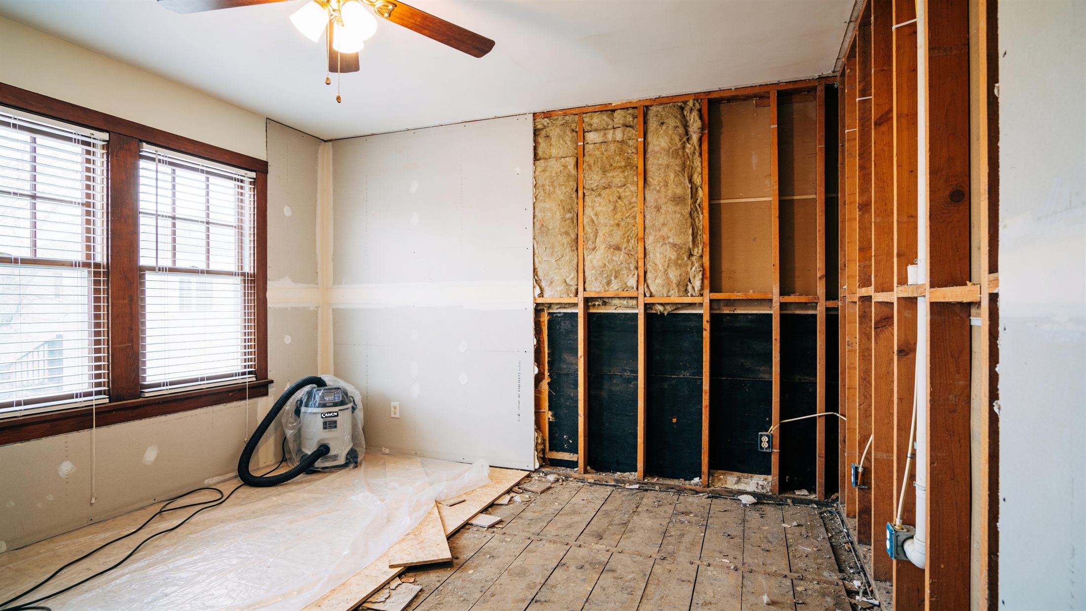 Neat flood cut with exposed studs during controlled demolition